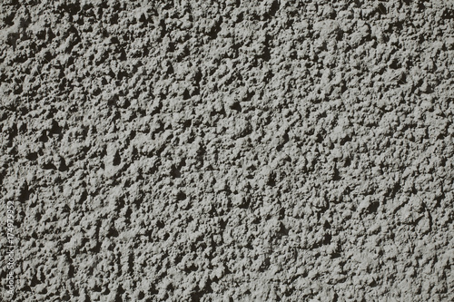 Grainy and noisy gray concrete wall pattern texture.