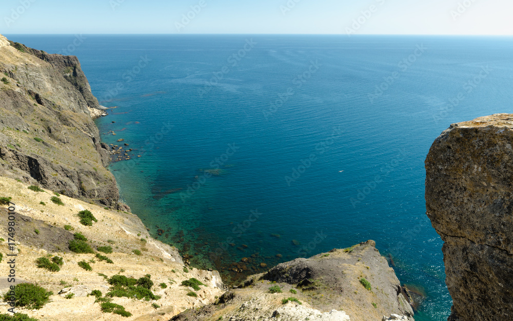 Fiolent Cape Crimea Black Sea. Blue azure seaside with corals sand and stones