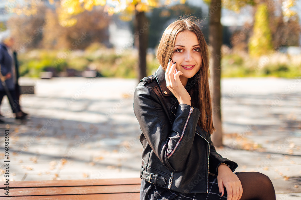Young girl talk on the phone at park background Young girl talk on the phone at park background