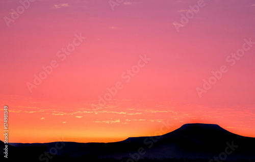 Sunset  View looking over damaraland in Namibia  with a bright pink sky and silhouette of mountains