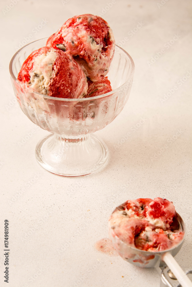 Strawberry and vanilla ice cream in a glass.