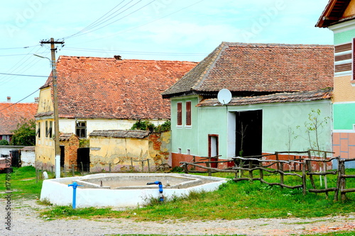 Typical rural landscape and peasant houses in Barcut, Bekokten, Brekolten, Transylvania, Romania photo