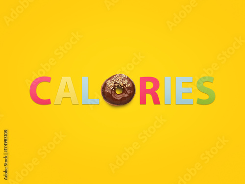 Bright composition of doughnut and word calories photo