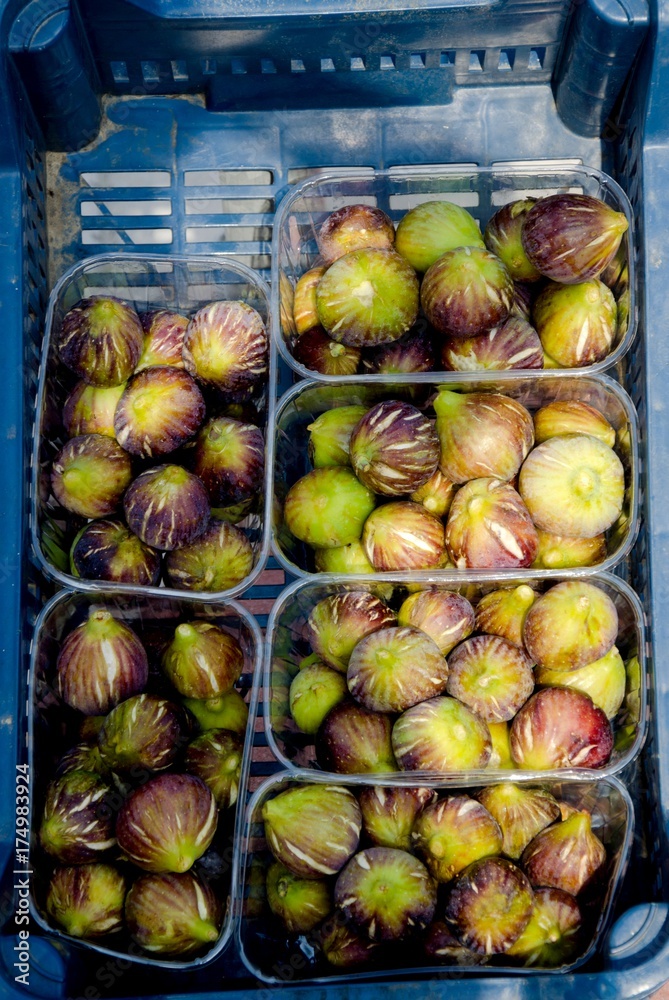 figs in plastic crates on market for sale 
