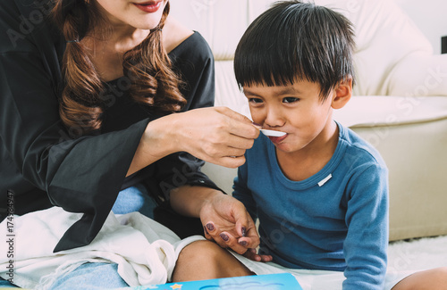 The mother a enter medication the boy.