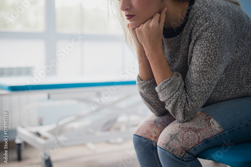 Woman's hand waiting for doctor in hospital feeling worried. photo