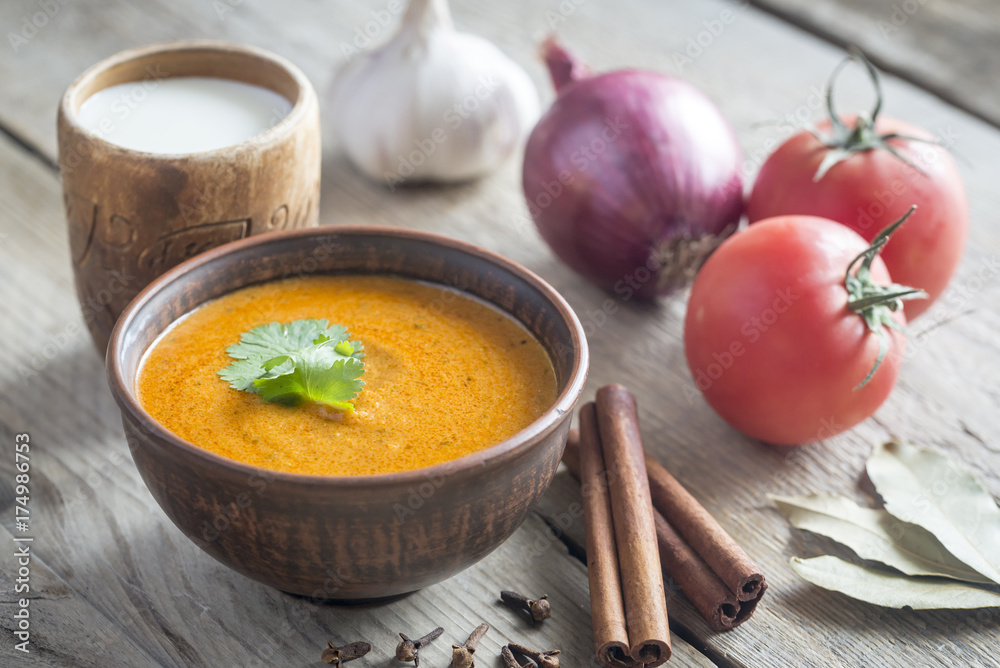 Bowl of butter chicken with ingredients Bowl of butter chicken with ingredients