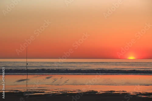 Colourful sunset or sunrise over sea and waves as background