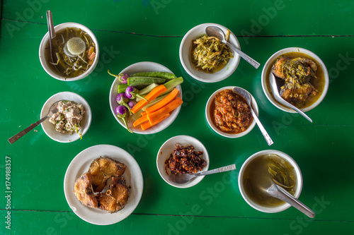 Top view at the table with assorted burmese food in local restaurant in Myanmar.