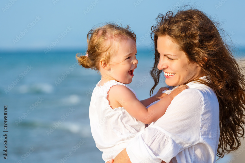 Portrait of mother and little daughter on the beach Portrait of mother and little daughter on the beach