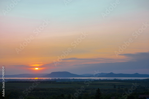 Colorful sunset with the Lake Balaton and the Badacsony mountain in the background