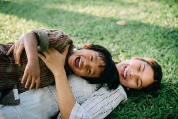 child with mother playing at park,happy family concept.