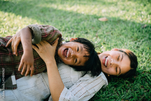 child with mother playing at park,happy family concept.