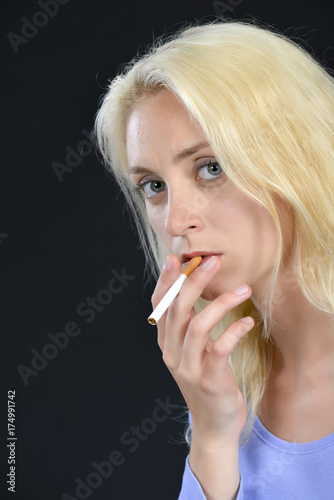 Blond woman having a cigarette