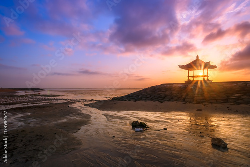 Beautiful sunrise on a beach in Bali Indonesia with colourful sky as background photo