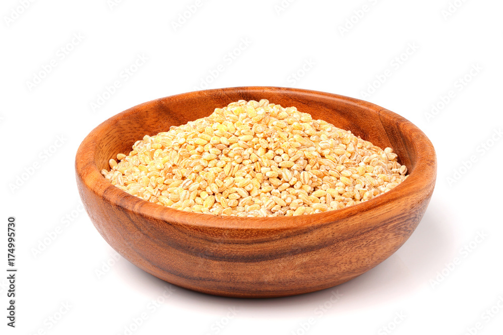 Pearl barley in wooden bowl isolated. Pearl barley in wooden bowl isolated.