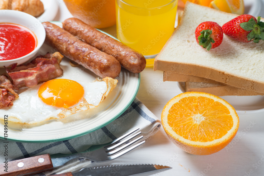 Nutritious breakfast, strawberry, bread, coffee orange juice, sausage, egg Nutritious breakfast, strawberry, bread, coffee orange juice, sausage, egg