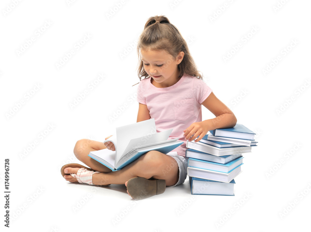 Cute little girl reading books on white background Cute little girl reading books on white background