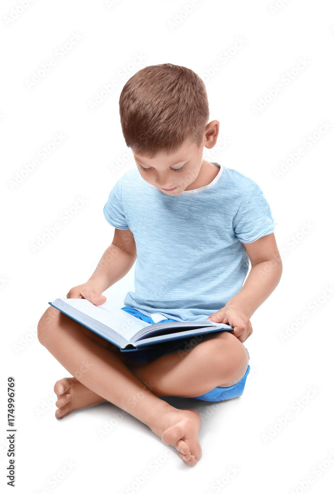 Cute little boy reading book on white background Cute little boy reading book on white background