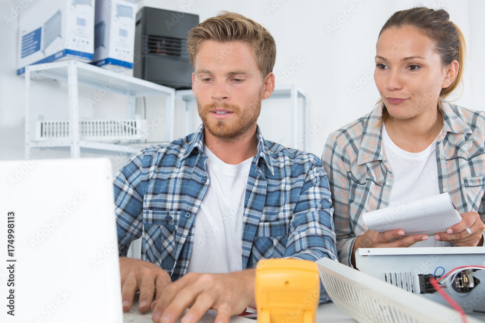 female and male technician working with transistor in laboratory