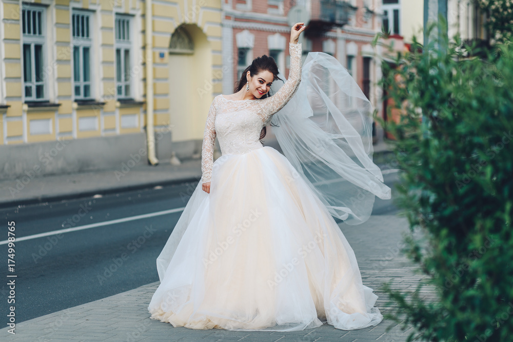 Portrait of a beautiful girl in a wedding dress posing