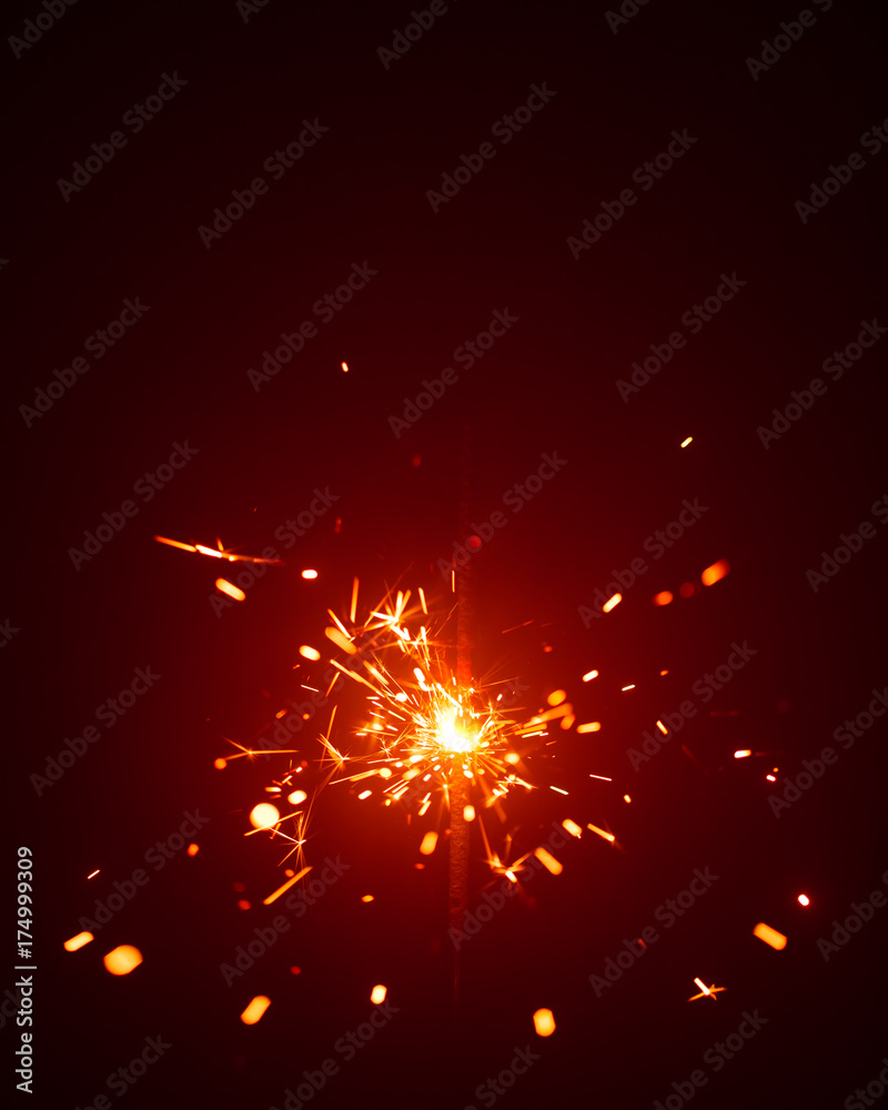 Obraz premium Christmas sparkler in haze with red light