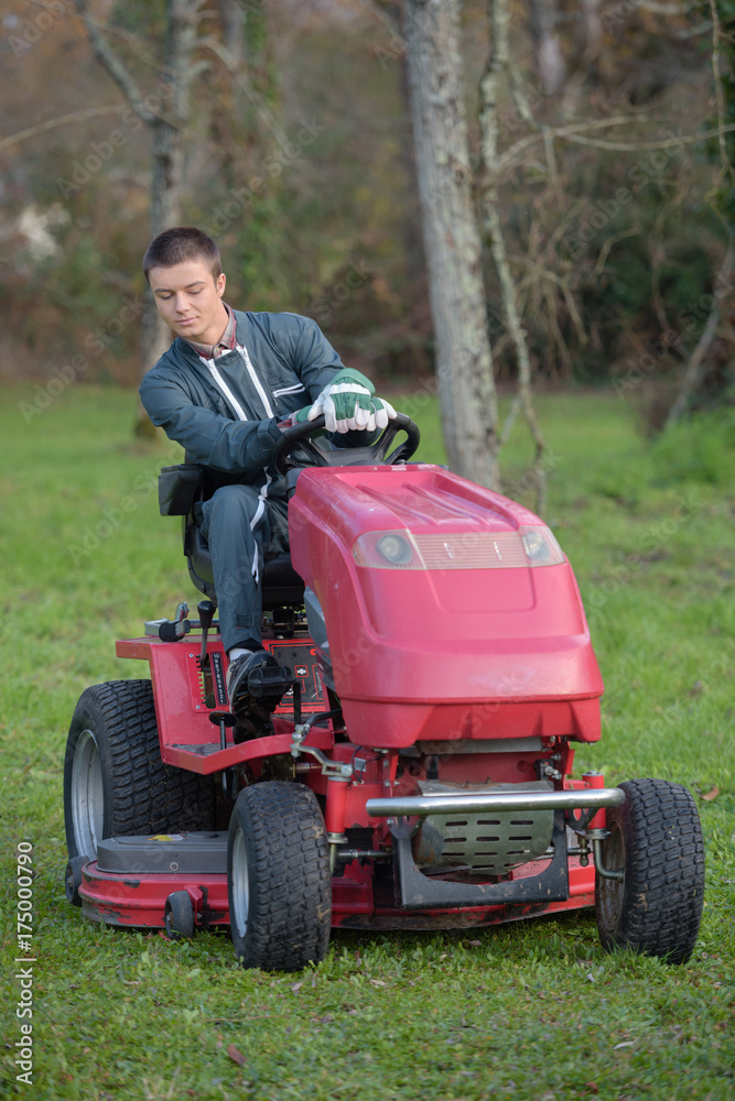 Young man driving mower Young man driving mower