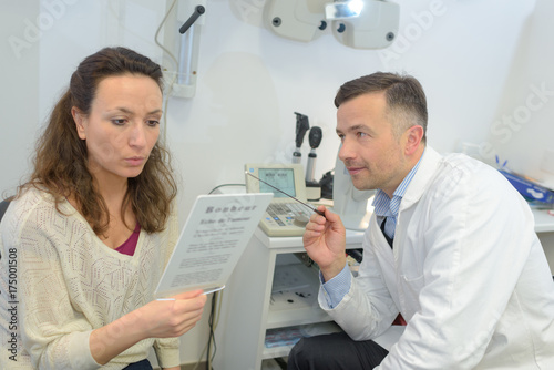 ophthalmologist asking patient to read page