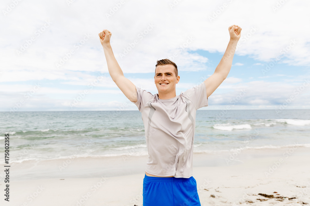 Young man in sport wear with outstretched arms Young man in sport wear with outstretched arms