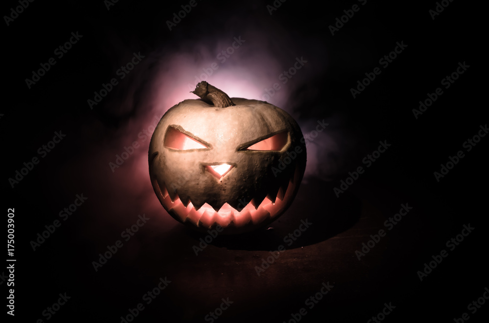 Fototapeta premium Halloween - old jack-o-lantern on black background. Closeup of scary halloween pumpkins