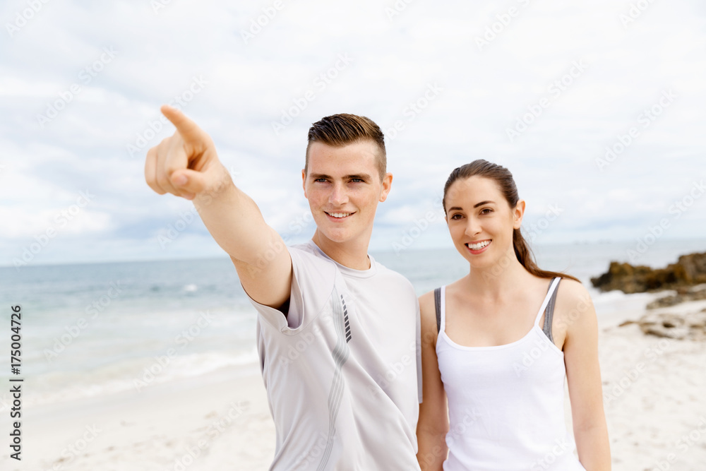 Couple of runners standing together on beach Couple of runners standing together on beach