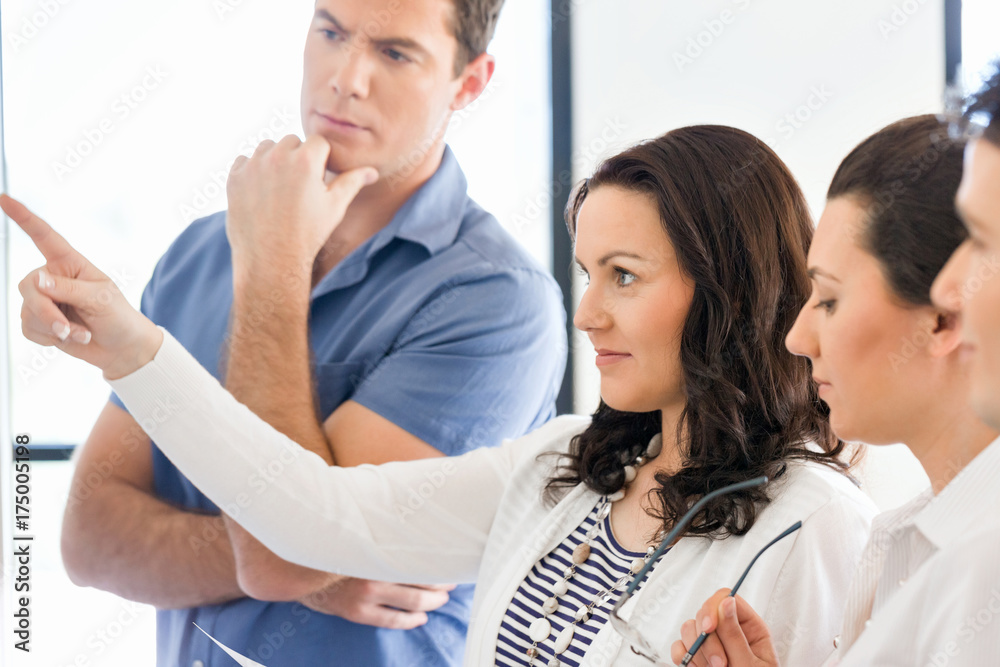 Image of business partners discussing documents and ideas