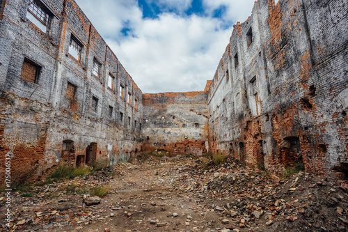 Ruined red brick industrial building. Abandoned and destroyed sugar factory in Novopokrovka, Tambov region photo