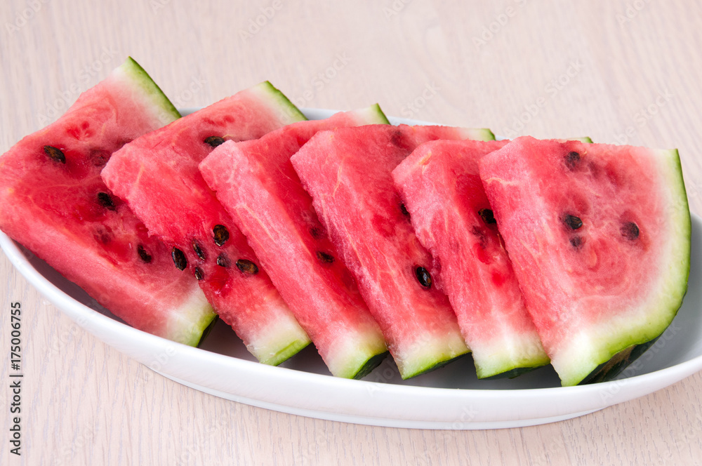 Ripe watermelon slices in a plate is on the table Ripe watermelon slices in a plate is on the table