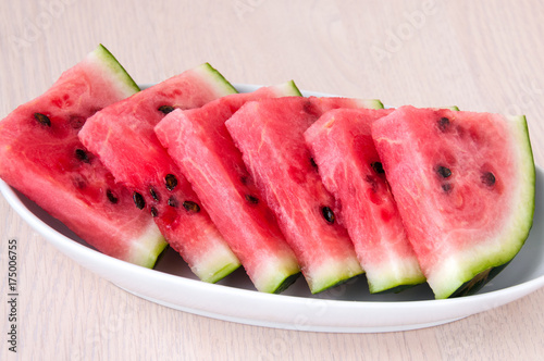 Ripe watermelon slices in a plate is on the table