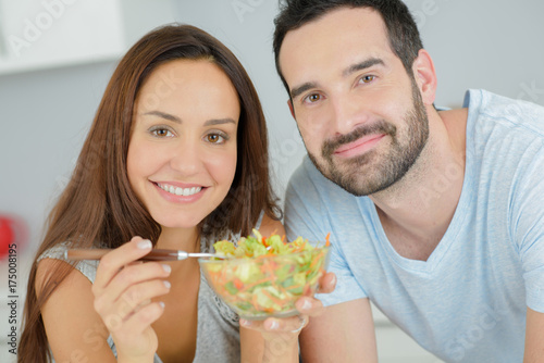 happy couple eating vegetable salad