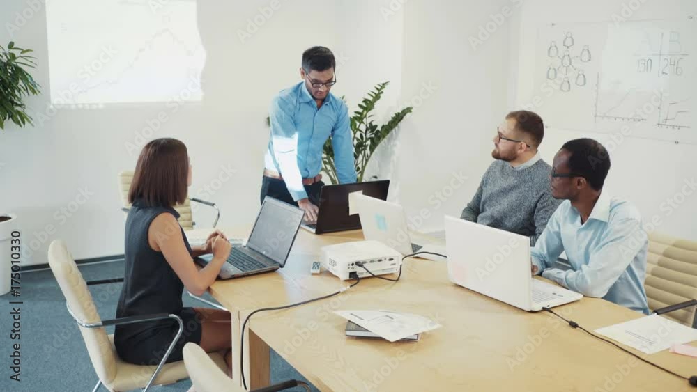 Business team discuss new projects. Uses a laptop in the office. Business concept, metting, project, strategy, team, casual, coworker. Shot on RED Epic Camera Business team discuss new projects. Uses a laptop in the office. Business concept, metting, project, strategy, team, casual, coworker. Shot on RED Epic Camera