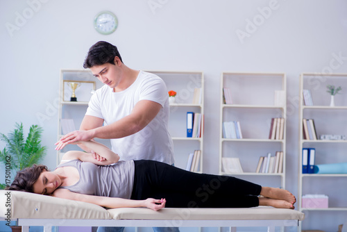 Young doctor chiropractor massaging female patient woman