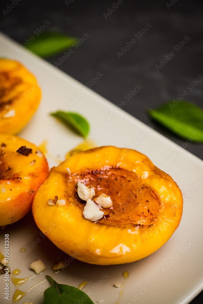 Grilled peaches on the rustic background. Shallow depth of field. Selective focus. Grilled peaches on the rustic background. Shallow depth of field. Selective focus.