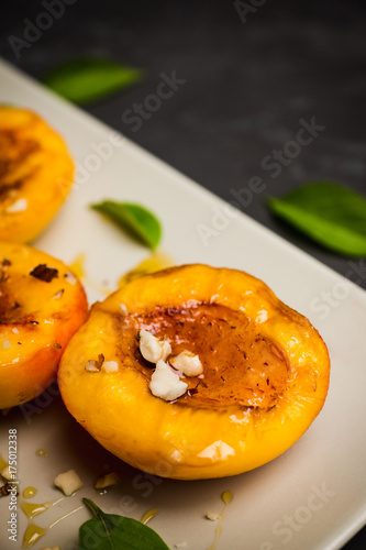 Grilled peaches on the rustic background. Shallow depth of field. Selective focus.