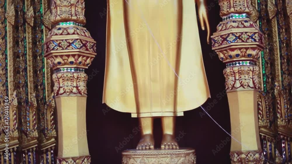 Golden Buddha statue with hand raised in a temple. 1920x1080 Golden Buddha statue with hand raised in a temple. 1920x1080