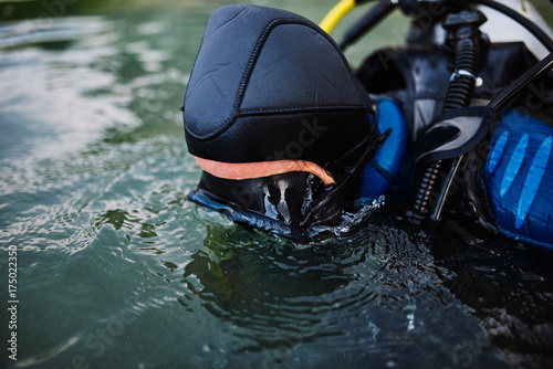 Diver in swimming mask looking underwater