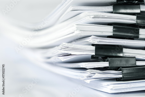 extreamly close up the stacking of office working document with paper clip folder