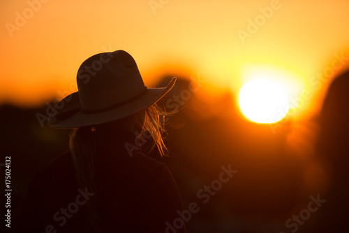 cowgirl with hat in the sunset photo