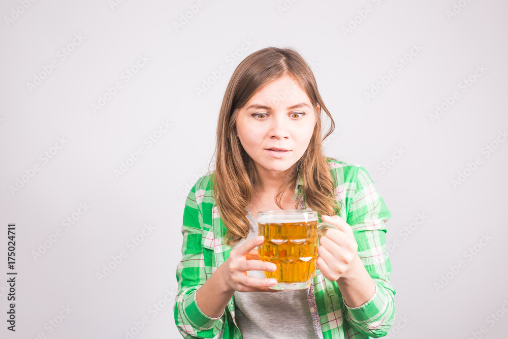 Beautiful woman holding a mug of beer. Background with copy space Beautiful woman holding a mug of beer. Background with copy space
