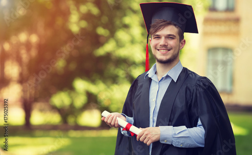 Happy man portrait on her graduation day University. Education and people.