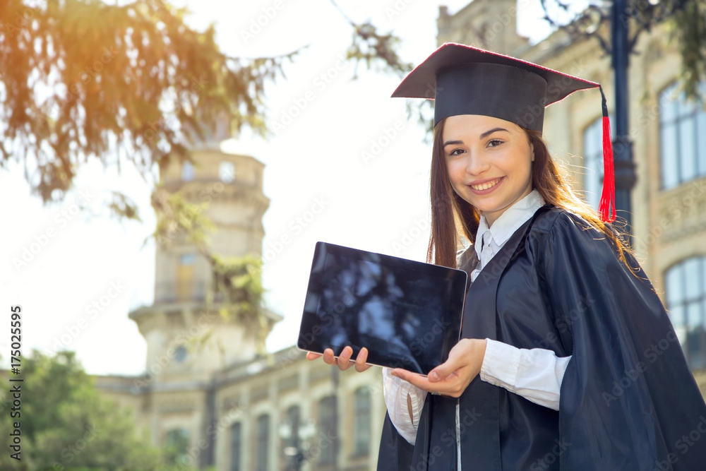 Woman on her graduation day. Use tablet pc. University, education and happy people - concept. Woman on her graduation day. Use tablet pc. University, education and happy people - concept.