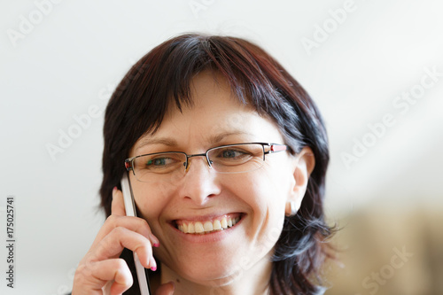 smiling middle-aged woman call by phone