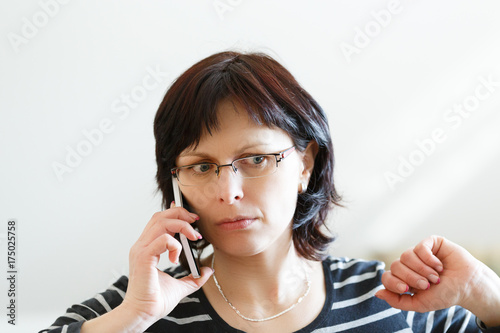 tired middle-aged woman call by phone