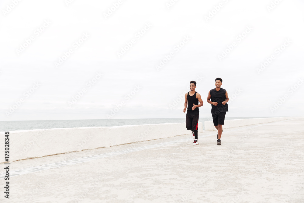 African happy sports men friends running outdoors